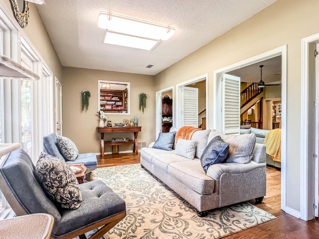 living room with hardwood / wood-style flooring and a textured ceiling