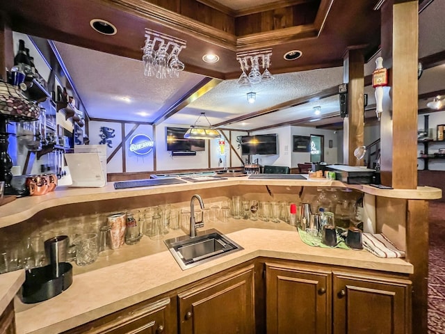 bar with sink and a textured ceiling