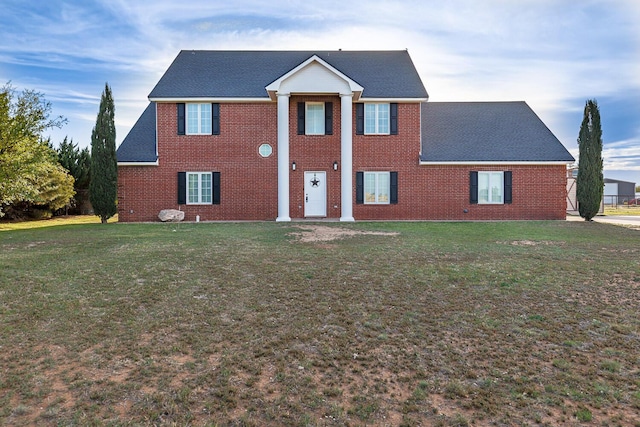 4306 Alcove Ave, Lubbock, TX 79407 - neoclassical / greek revival house with a front yard, roof with shingles, and brick siding