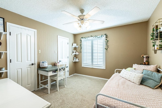 4306 Alcove Ave, Lubbock, TX 79407 - bedroom with a textured ceiling, carpet flooring, baseboards, and a ceiling fan