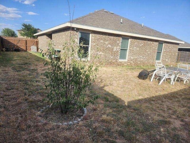 back of house with a lawn