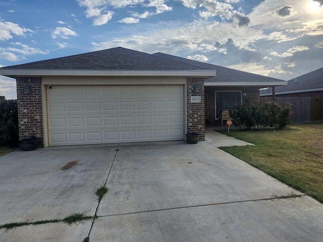 ranch-style house with a garage and a front lawn