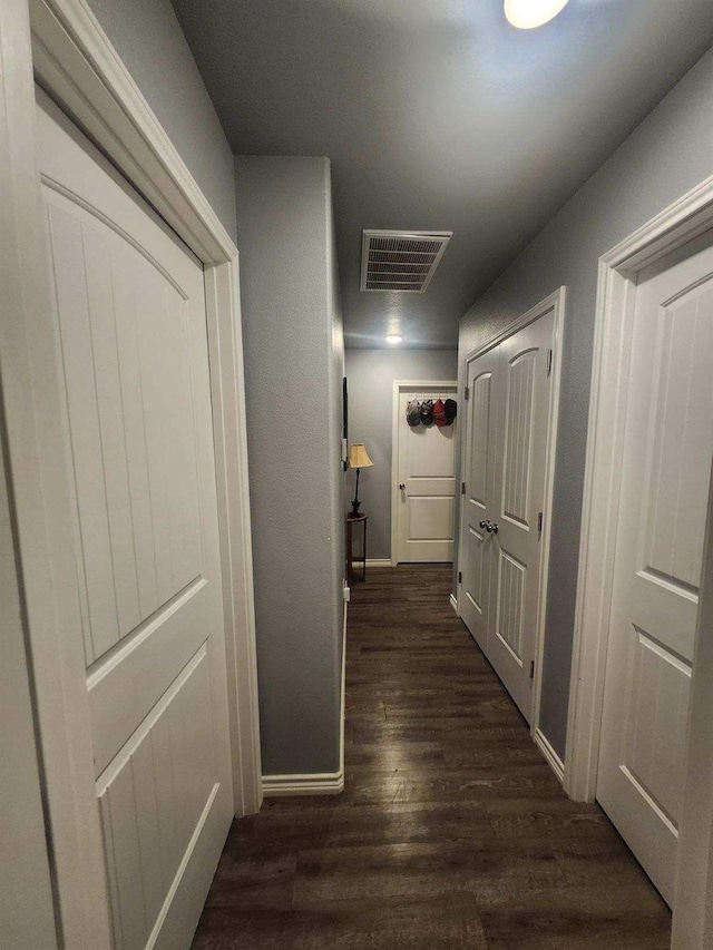 corridor with dark hardwood / wood-style floors