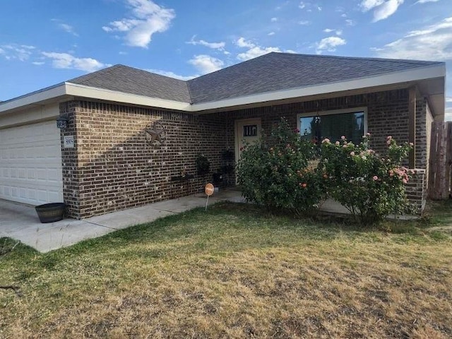 exterior space with a garage and a yard