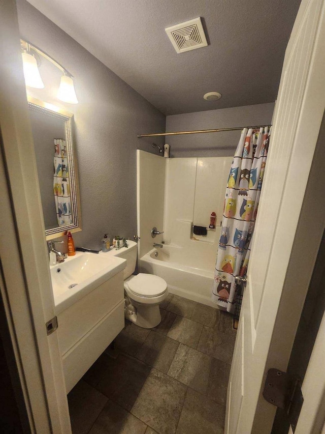 full bathroom featuring vanity, toilet, shower / tub combo, and a textured ceiling