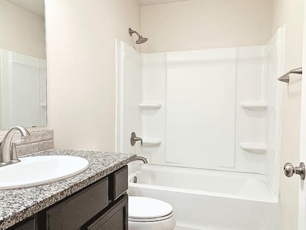 full bathroom featuring vanity, toilet, and shower / bath combination