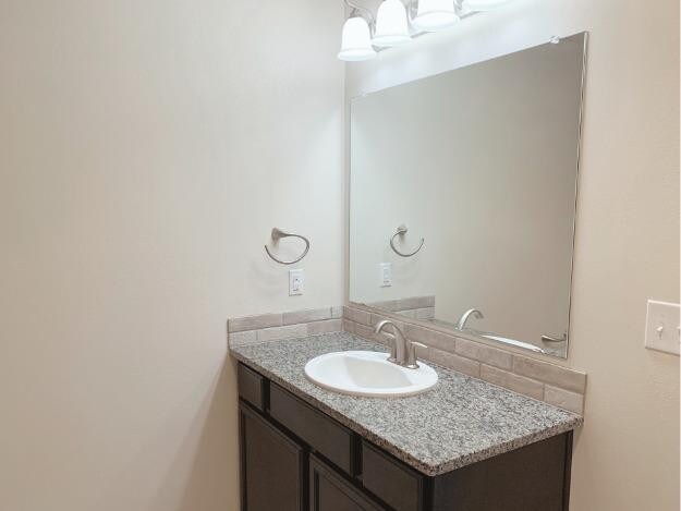 bathroom with vanity and backsplash