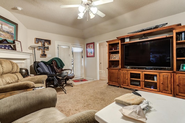 living room featuring ceiling fan, carpet flooring, and a textured ceiling