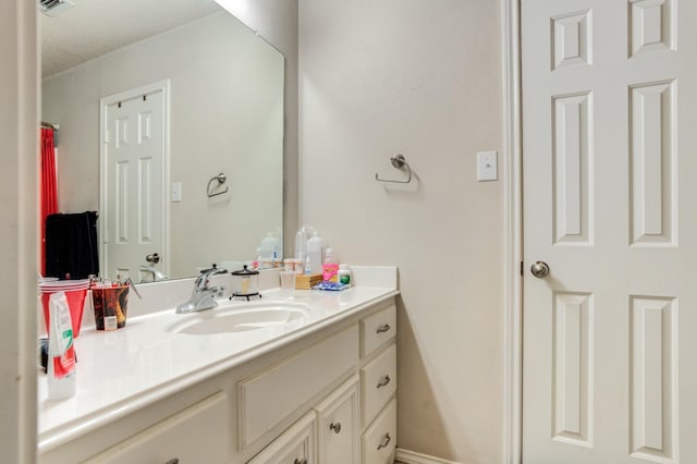 bathroom with vanity and a textured ceiling