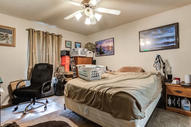 carpeted bedroom with ceiling fan and a textured ceiling