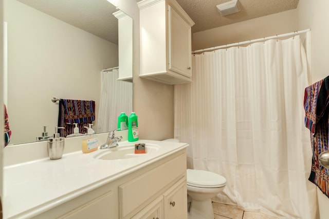 bathroom featuring tile patterned floors, toilet, a textured ceiling, and vanity