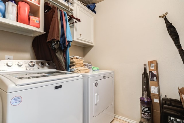 laundry room with cabinets and washer and dryer