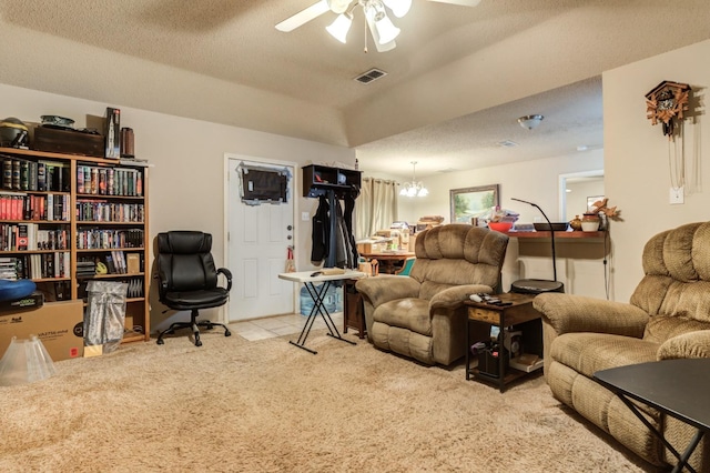 tiled living room featuring ceiling fan with notable chandelier and a textured ceiling