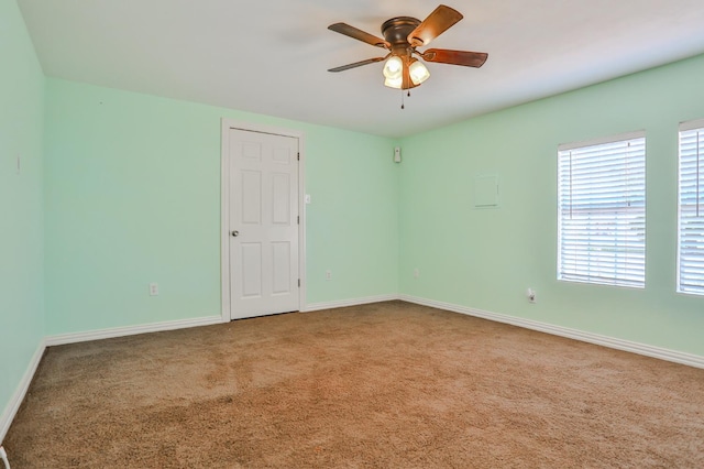 empty room with carpet flooring and ceiling fan