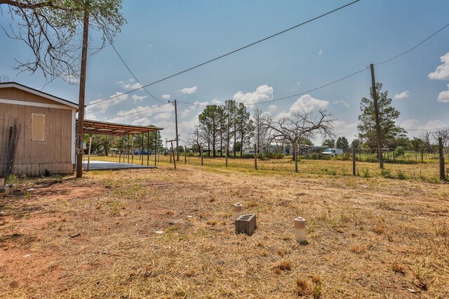 view of yard with a rural view