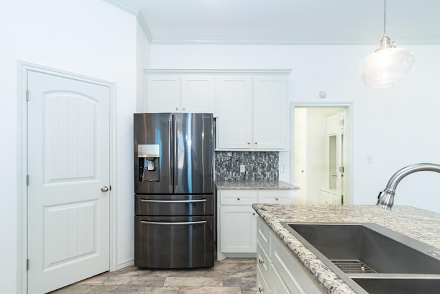 9610 Kline Ave, Lubbock, TX 79424 - kitchen featuring stainless steel fridge with ice dispenser, white cabinetry, decorative backsplash, and a sink