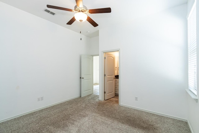 9610 Kline Ave, Lubbock, TX 79424 - unfurnished bedroom with light carpet, baseboards, visible vents, and ceiling fan