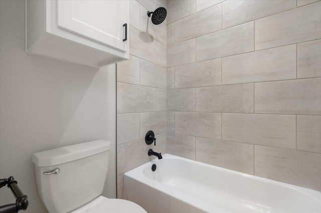 bathroom with tiled shower / bath combo and toilet