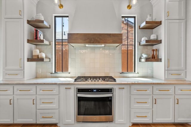 kitchen featuring premium range hood, appliances with stainless steel finishes, and white cabinets