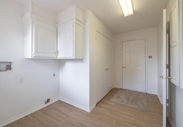 laundry room featuring light wood finished floors, baseboards, washer hookup, cabinet space, and electric dryer hookup