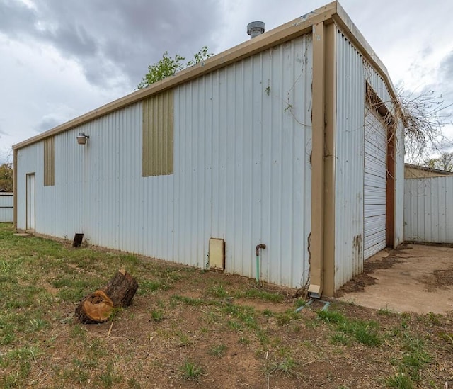 view of side of home with an outdoor structure and an outbuilding