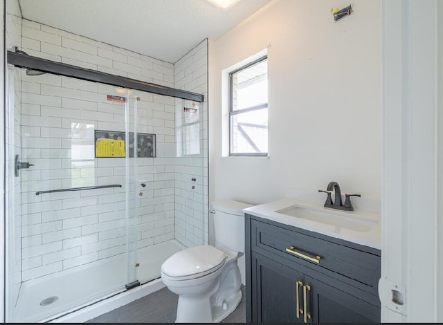 full bathroom with toilet, vanity, and a stall shower