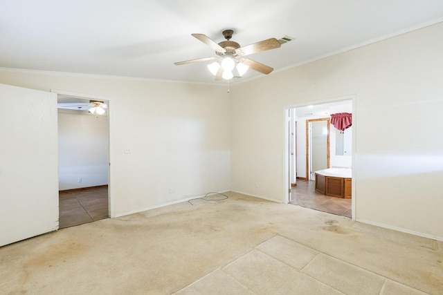 unfurnished bedroom featuring light carpet, ensuite bath, ornamental molding, and ceiling fan