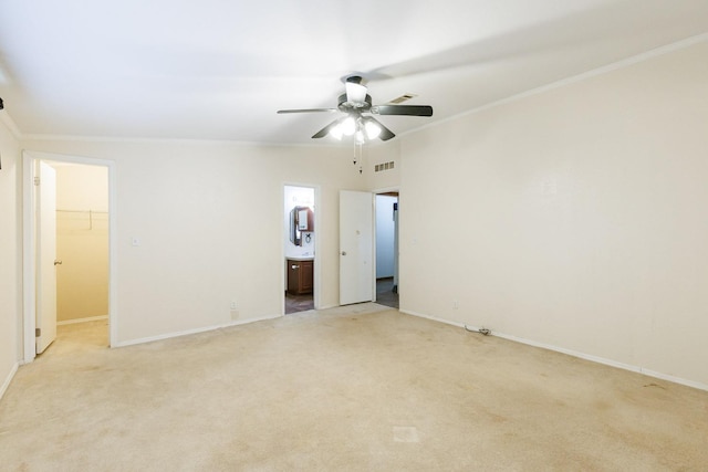 carpeted spare room with crown molding and ceiling fan