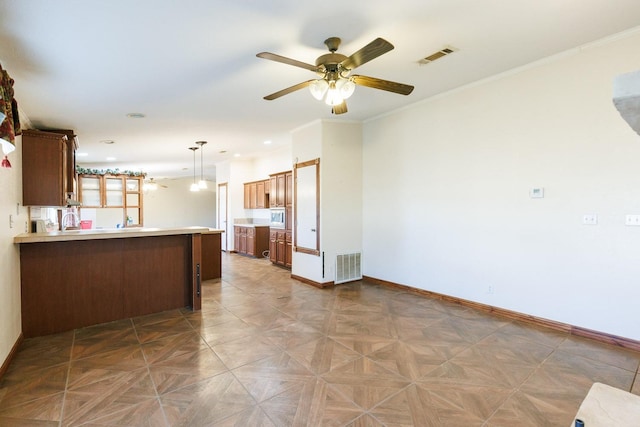 kitchen with parquet flooring, crown molding, hanging light fixtures, kitchen peninsula, and ceiling fan