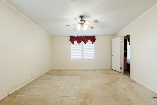 spare room with crown molding, light colored carpet, and ceiling fan