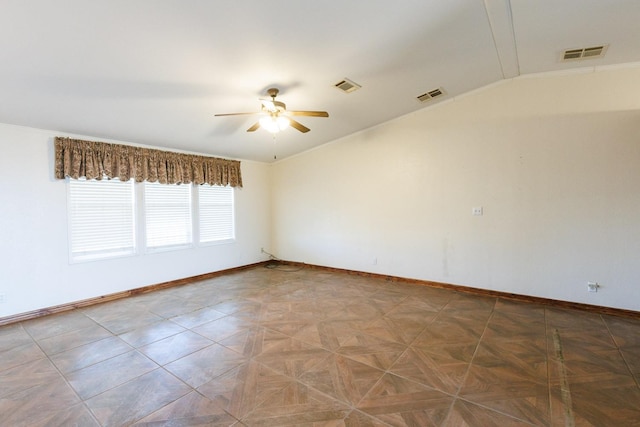 empty room with parquet floors, ceiling fan, and vaulted ceiling