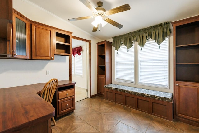 office space with dark parquet flooring, ornamental molding, and ceiling fan