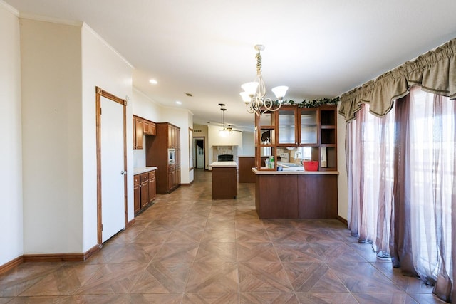 kitchen with pendant lighting, ornamental molding, dark parquet floors, and a chandelier