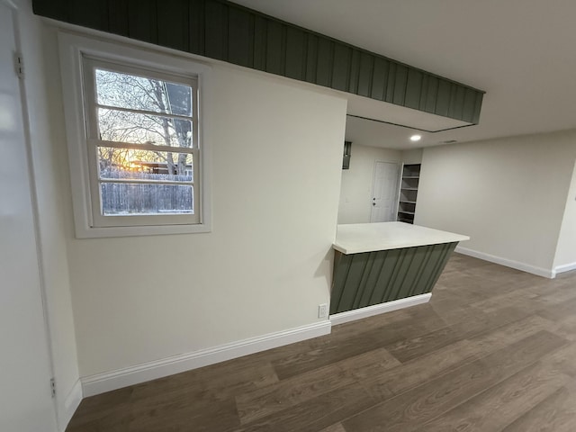 unfurnished room with baseboards and wood finished floors