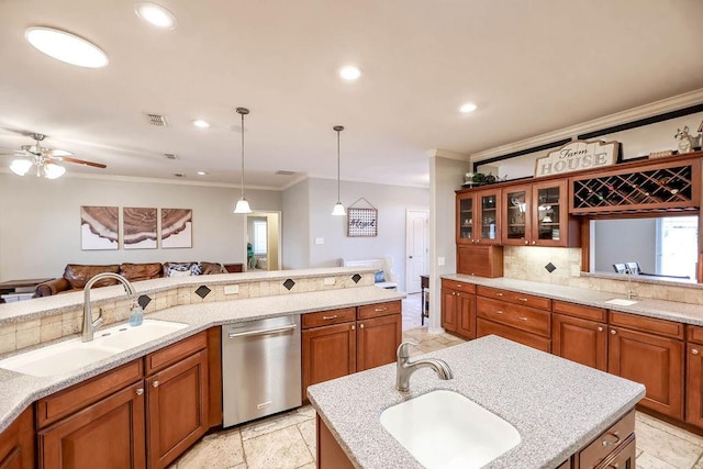 kitchen with sink, decorative backsplash, hanging light fixtures, and dishwasher