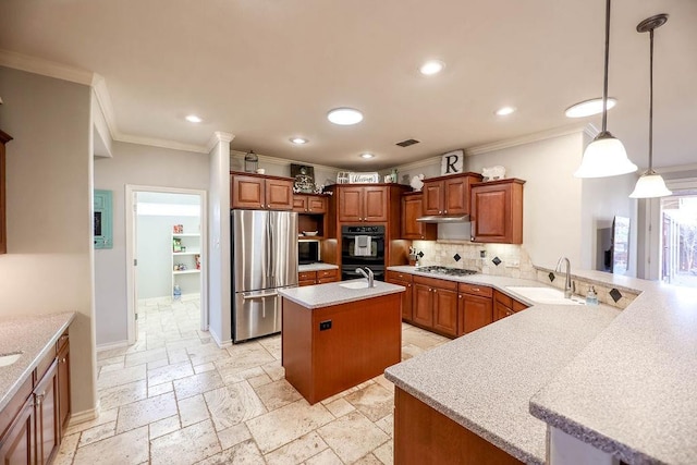 kitchen with pendant lighting, sink, a kitchen island with sink, stainless steel appliances, and kitchen peninsula