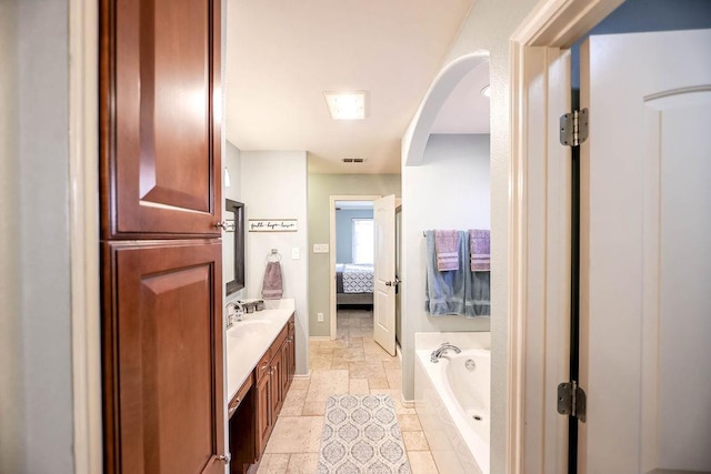 bathroom with vanity and a bathing tub