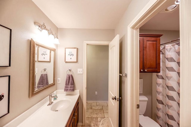 bathroom featuring vanity and toilet