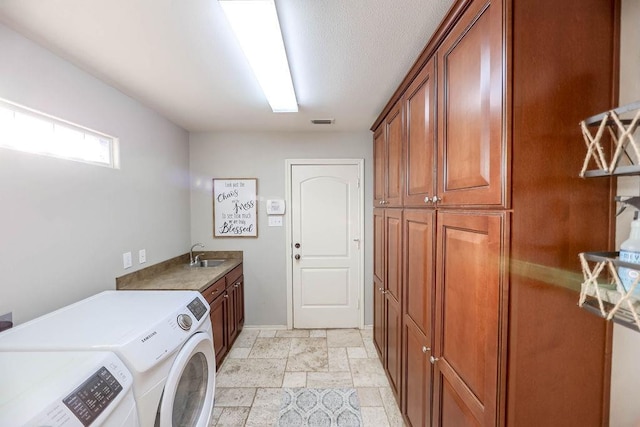 laundry area with cabinets, sink, and washing machine and clothes dryer