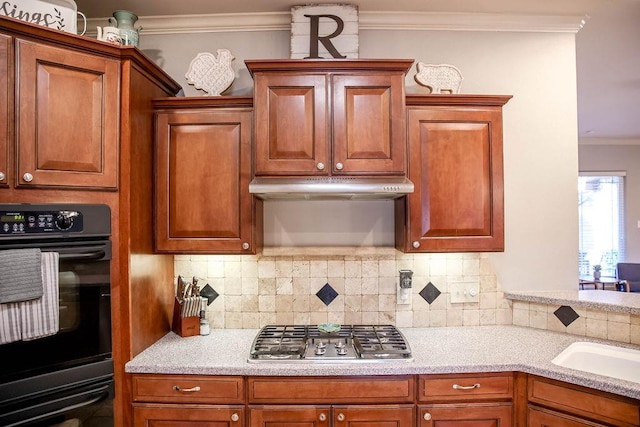 kitchen featuring double oven, backsplash, ornamental molding, light stone countertops, and stainless steel gas stovetop