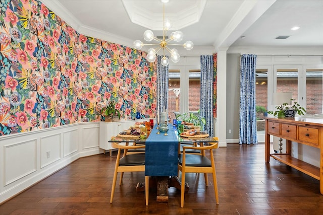 9214 York Pl, Lubbock, TX 79424 - dining room featuring crown molding, an inviting chandelier, a wainscoted wall, hardwood / wood-style floors, and visible vents