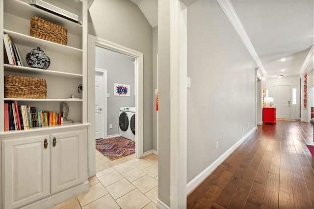 9214 York Pl, Lubbock, TX 79424 - hallway with baseboards, washing machine and dryer, ornamental molding, and light wood-style flooring