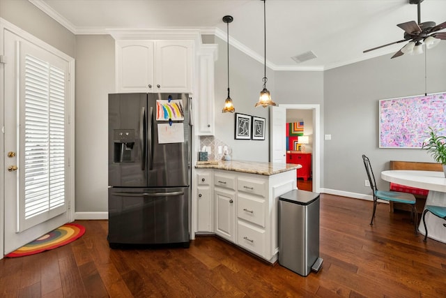 9214 York Pl, Lubbock, TX 79424 - kitchen with stainless steel fridge, baseboards, a peninsula, and white cabinetry