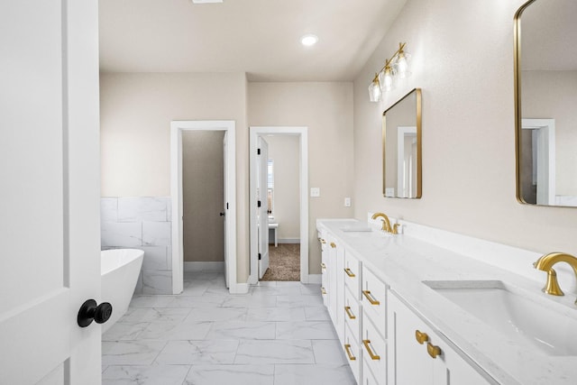 bathroom with vanity and a tub