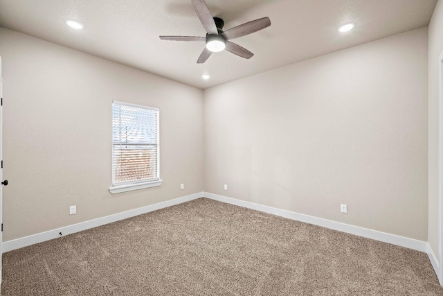 spare room featuring ceiling fan and carpet