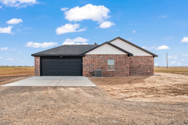 view of front of home featuring a garage and central AC unit