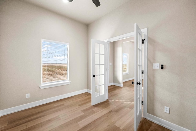 spare room featuring french doors, ceiling fan, and light hardwood / wood-style flooring