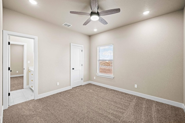 unfurnished bedroom with light colored carpet and ceiling fan