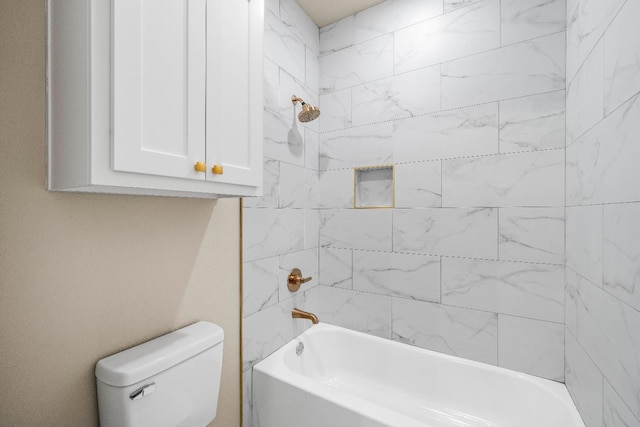 bathroom with tiled shower / bath combo and toilet