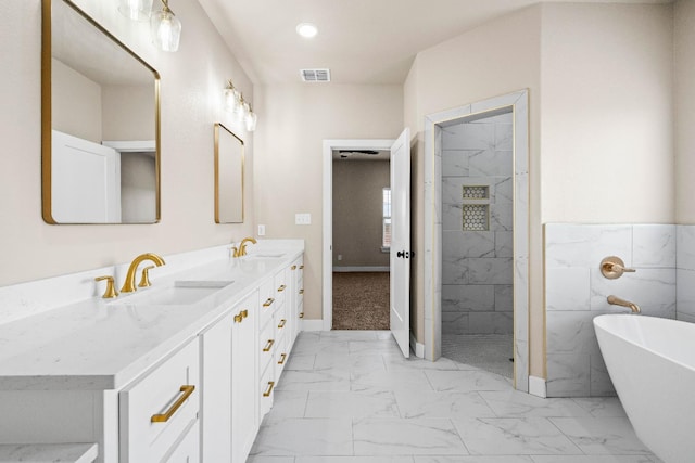 bathroom with vanity, tile walls, and separate shower and tub